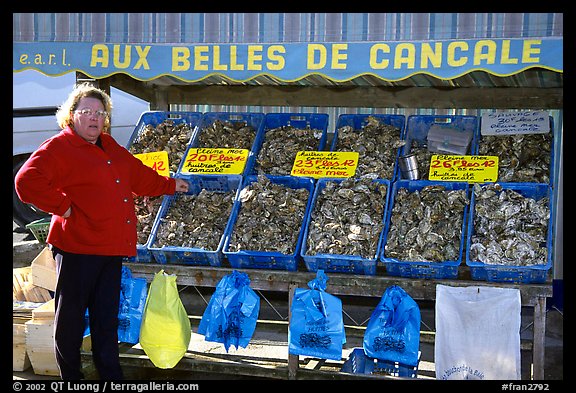 Oyster stand and vendor in Cancale. Brittany, France