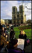 Sketch drawers in front of Notre Dame Cathedral. Paris, France (color)