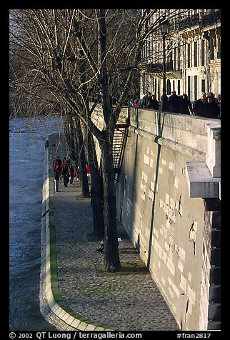 Walking on the banks of the Seine on the Saint-Louis island. Paris, France (color)