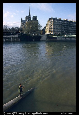 Fishing in the Seine river, Notre Dame Cathedral in the background. Paris, France