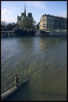 Fishing in the Seine river, Notre Dame Cathedral in the background. Paris, France ( color)