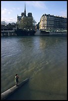 Fishing in the Seine river, Notre Dame Cathedral in the background. Paris, France (color)