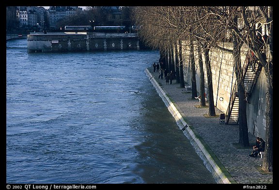 Walking on the banks of the Seine on the Saint-Louis island. Paris, France (color)