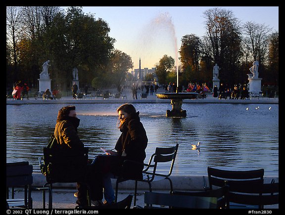 Couple sitting by basin in Tuileries Gardens. Paris, France (color)