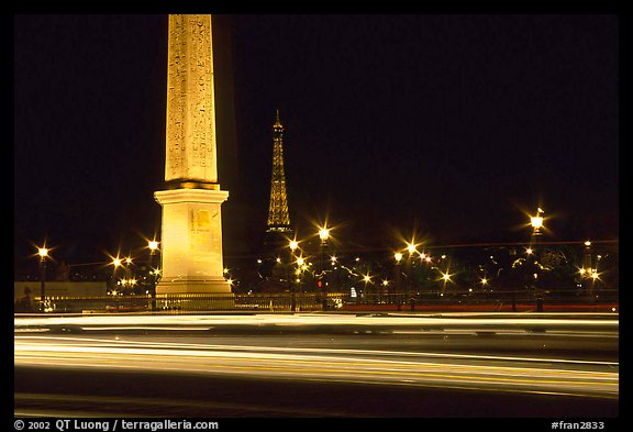 Car lights,  obelisk, and Eiffel Tower at night. Paris, France (color)