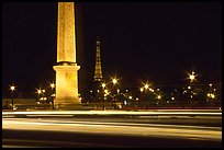 Car lights,  obelisk, and Eiffel Tower at night. Paris, France