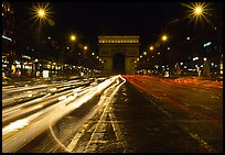 Arc de Triomphe seen from the middle of Champs Elysees at night. Paris, France (color)