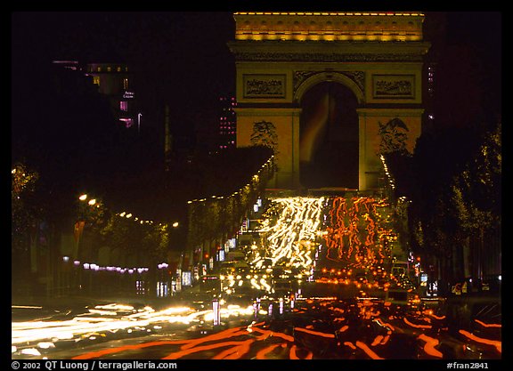 Arc de Triomphe and Champs Elysees at night with car light trails. Paris, France (color)