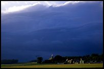 Stormy skies and village. France ( color)