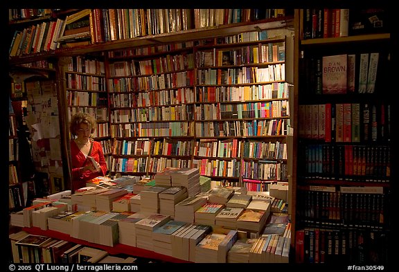 Checking a book in Shakespeare and Company bookstore. Quartier Latin, Paris, France (color)