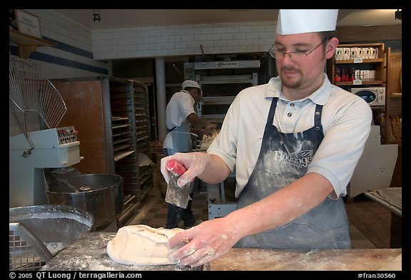 Baker preparing a loaf of break. Paris, France (color)