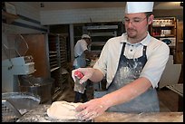 Baker preparing a loaf of break. Paris, France ( color)