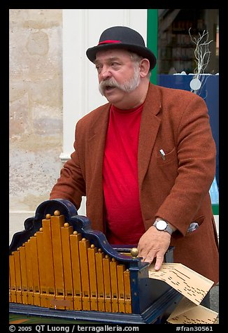 Street musician with Barrel organ. Quartier Latin, Paris, France (color)