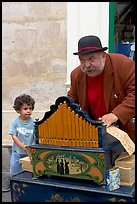 Barrel organ player and kid. Quartier Latin, Paris, France