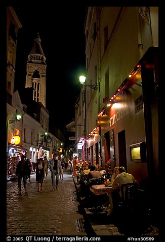 Dinners and narrow pedestrian street at night, Montmartre. Paris, France (color)