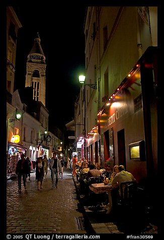 Dinners and narrow pedestrian street at night, Montmartre. Paris, France