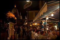 Outdoor dining at night on the Place du Tertre, Montmartre. Paris, France (color)