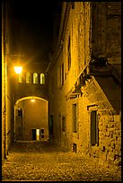 Cobblestone street by night inside medieval city. Carcassonne, France