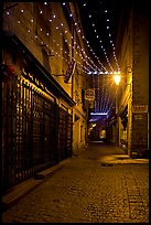 Lonely street by night with Tabac sign and Christmas lights. Carcassonne, France