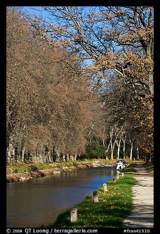 Walkway and boat along Canal du Midi. Carcassonne, France