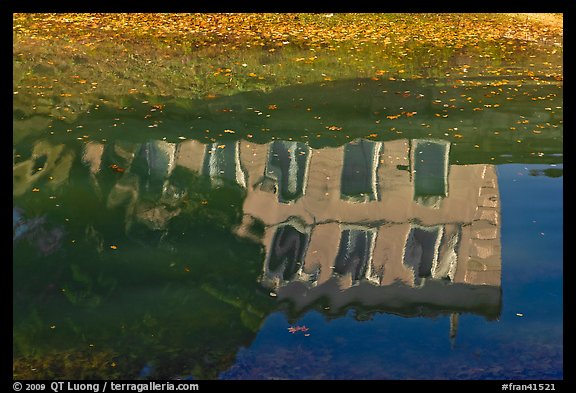 House reflections with fallen leaves, Canal du Midi. Carcassonne, France