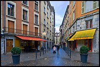 Pedestrian street with couple pushing stroller. Grenoble, France