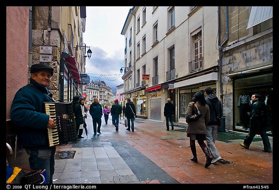 Accordeon musician on commercial pedestrian street. Grenoble, France