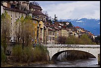 Stone bridge, houses, and snowy mountains. Grenoble, France (color)