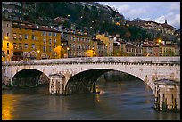 Bridge and brightly painted riverside houses at dusk. Grenoble, France (color)