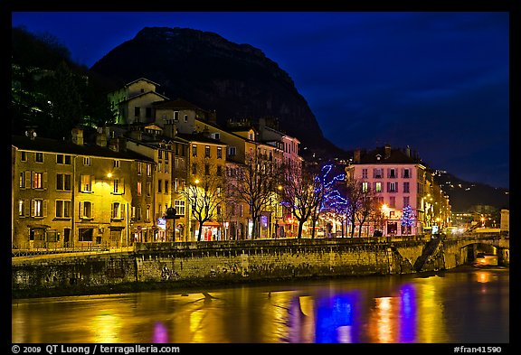 Isere River and houses below the Citadelle at night. Grenoble, France