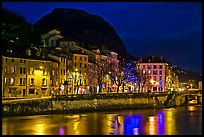 Isere River and houses below the Citadelle at night. Grenoble, France