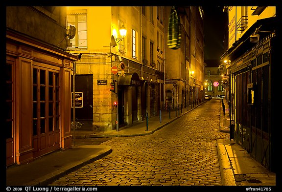 Narrow cobblestone street in historic district at night. Lyon, France