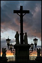 Cross and statues with sunset clouds. Avignon, Provence, France