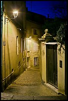 Narrow cobblestone street and street light. Avignon, Provence, France