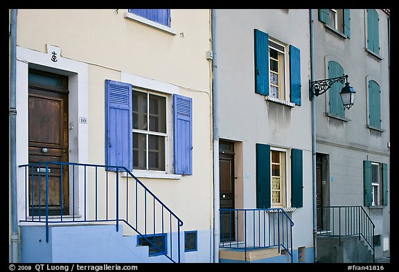 Facade of townhouses with colorful shutters. Arles, Provence, France (color)