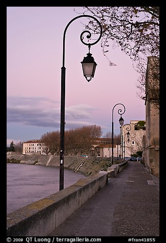 Walkway on the banks of the Rhone River at dusk. Arles, Provence, France