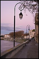 Walkway on the banks of the Rhone River at dusk. Arles, Provence, France (color)