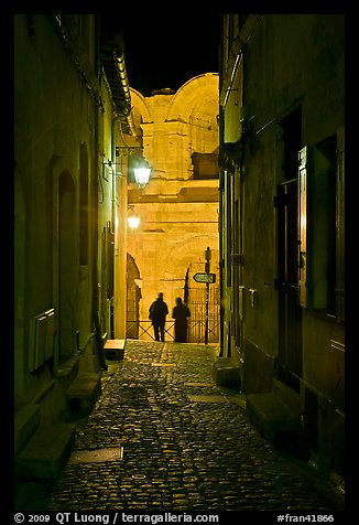 Narrow cobblestone passageway at night next to arena. Arles, Provence, France (color)