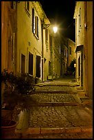 Cobblestone passageway with stepts at night. Arles, Provence, France