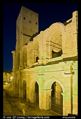 Arenes Roman amphitheater with defensive tower at night. Arles, Provence, France