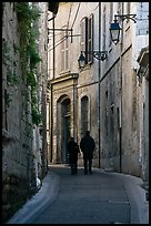 Couple walking in old street. Arles, Provence, France