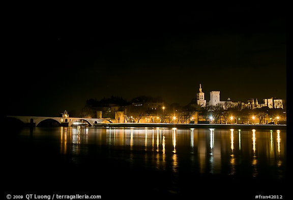 Avignon skyline at night with lights reflected in Rhone River. Avignon, Provence, France