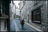 Boy walking in narrow street, Chartres. France (color)