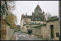 Street with couple walking and Caesar's Tower in background, Provins. France