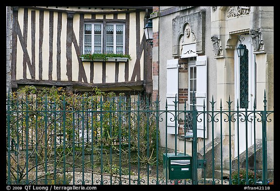 Fence, stone house, and half-timbered house, Provins. France