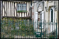 Fence, stone house, and half-timbered house, Provins. France (color)