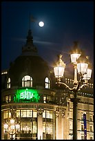 Street lamps, BHV department store, and moon. Paris, France