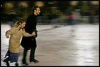 Man skating with daughter by night. Paris, France (color)