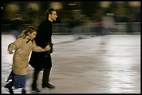 Man skating with daughter by night. Paris, France