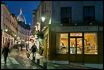 Bakery, street and dome of Sacre-Coeur at twilight, Montmartre. Paris, France